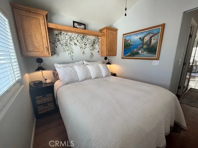 70201 Aurora Road, Unit 176 Desert Hot Springs, CA 92240 - Photo 8 of 17 a bed room with a bed and a painting on the wall