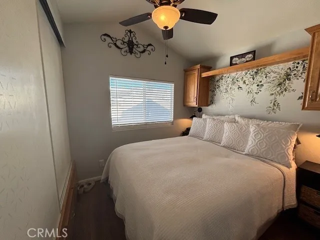 70201 Aurora Road, Unit 176 Desert Hot Springs, CA 92241 - Photo 9 of 17 a bedroom with a bed and a chandelier