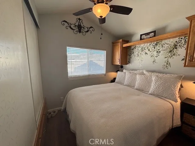 70201 Aurora Road, Unit 176 Desert Hot Springs, CA 92240 - Photo 9 of 17 a bedroom with a bed and a chandelier