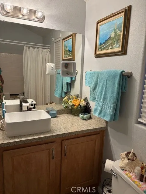 70201 Aurora Road, Unit 176 Desert Hot Springs, CA 92241 - Photo 10 of 17 a bathroom with a sink mirror and toilet