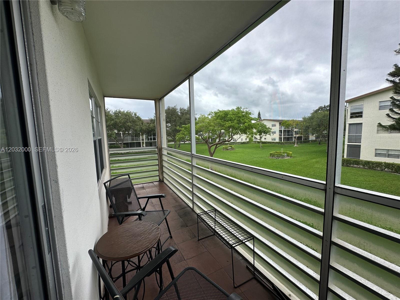 445 Mansfield K, Unit 445 Boca Raton, FL 33434 - Photo 9 of 12 a view of a two chair in the balcony