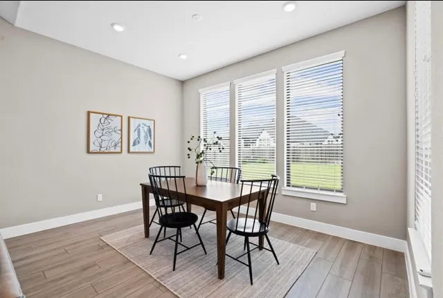 a dining room with furniture and wooden floor