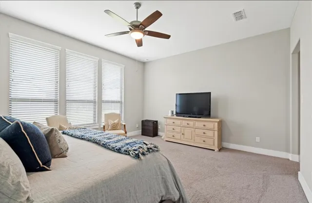 a bedroom with furniture and flat screen tv
