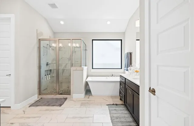 a bathroom with a granite countertop sink a toilet and shower