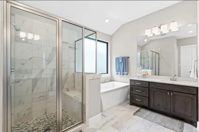 a bathroom with a double vanity sink mirror and shower