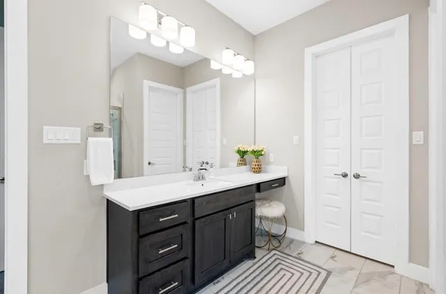 a bathroom with a sink a mirror and a shower