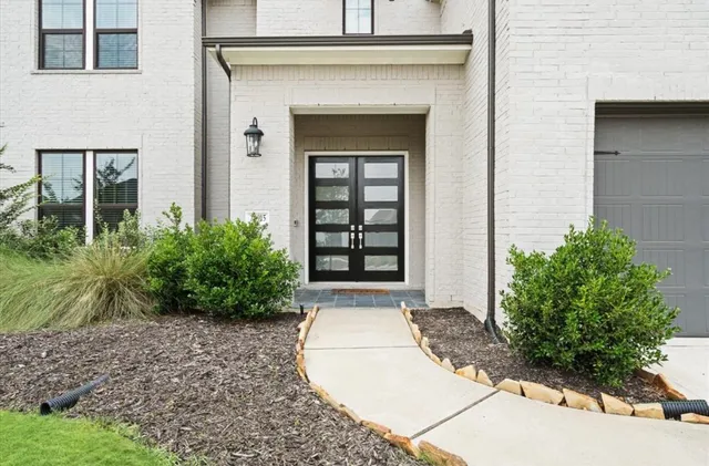 a view of a house with potted plants