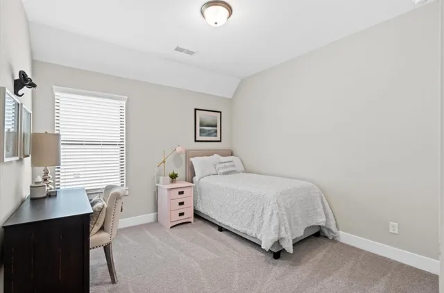 a bedroom with a bed and a desk