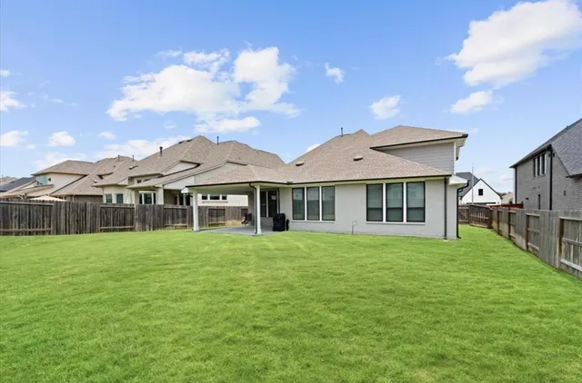 a view of a big house with a big yard and potted plants