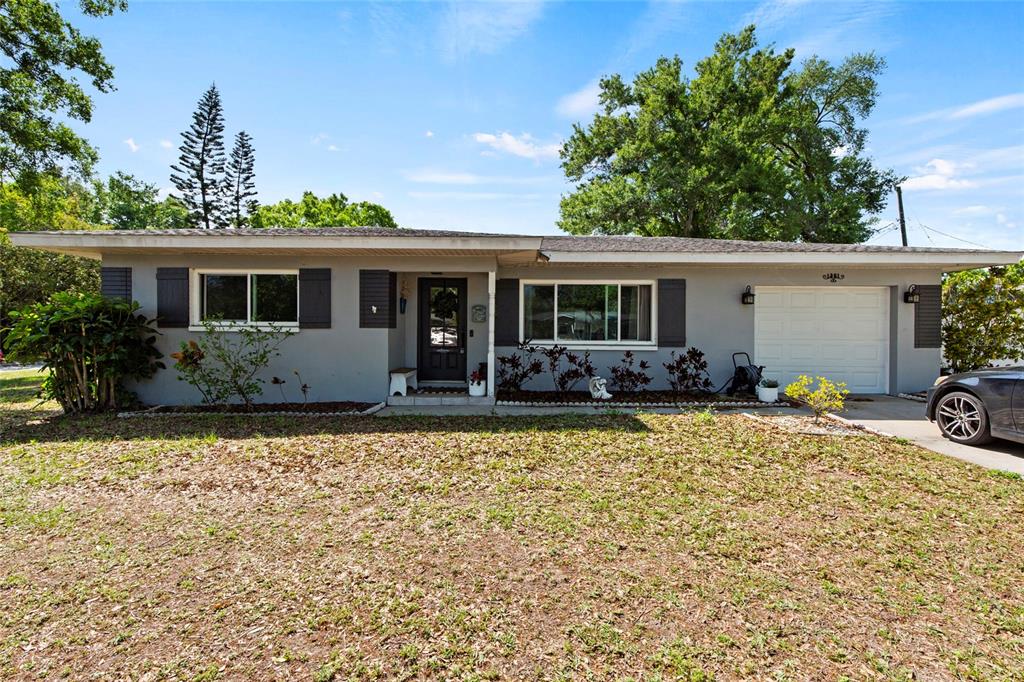 a view of a house with backyard sitting area and garden