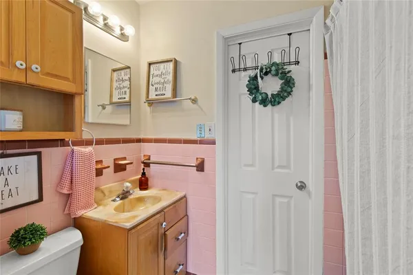 a bathroom with a sink a toilet and mirror
