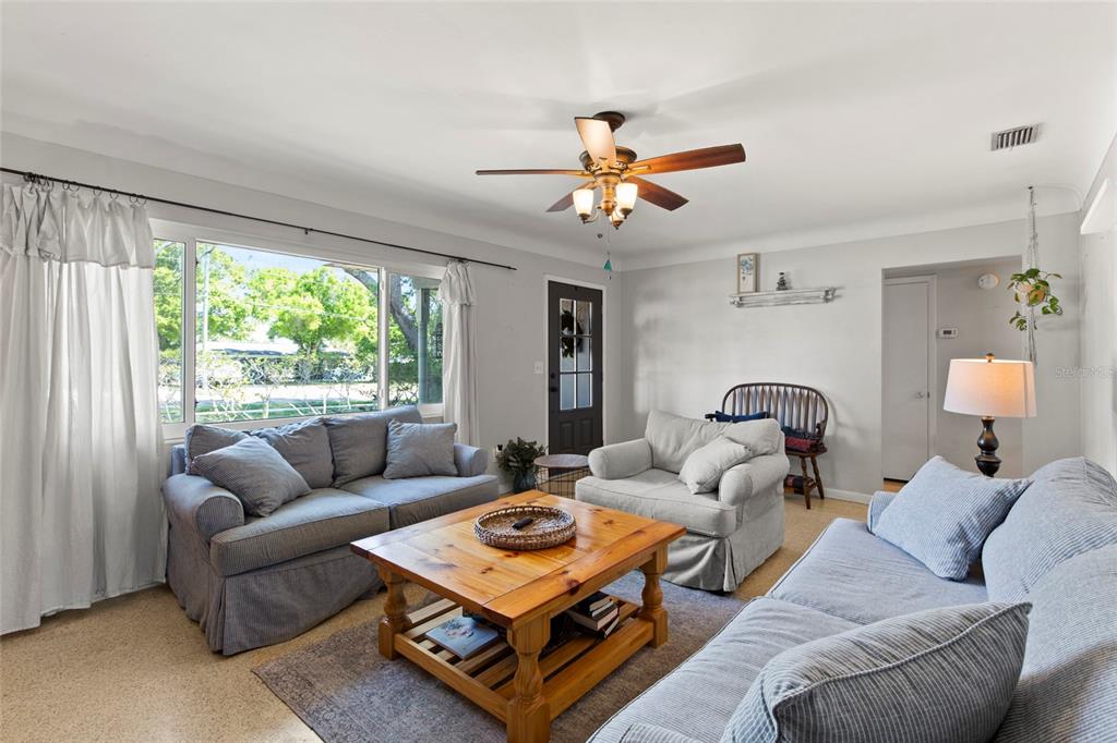 1361 Belleair Road Clearwater, FL 33756 - Photo 4 of 19 a living room with furniture a table and a large window