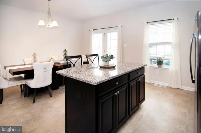 a kitchen with a center island and some windows