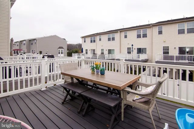 a roof deck with a table and a chairs