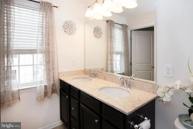a bathroom with a sink vanity and a mirror