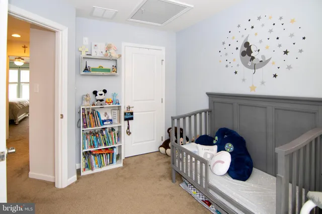 a bedroom with furniture and book shelf