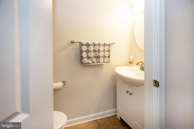 a bathroom with a sink toilet and mirror