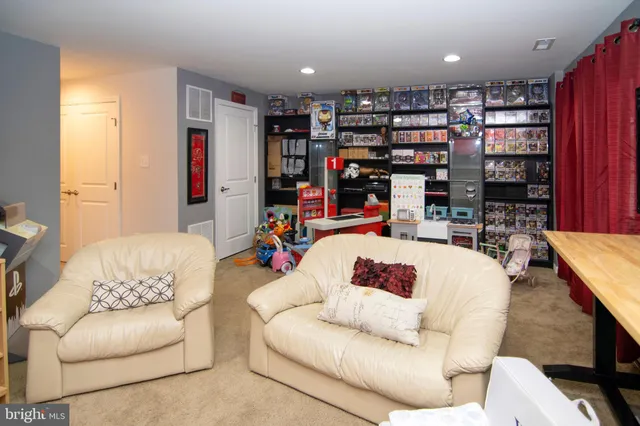 a living room with furniture and a book shelf