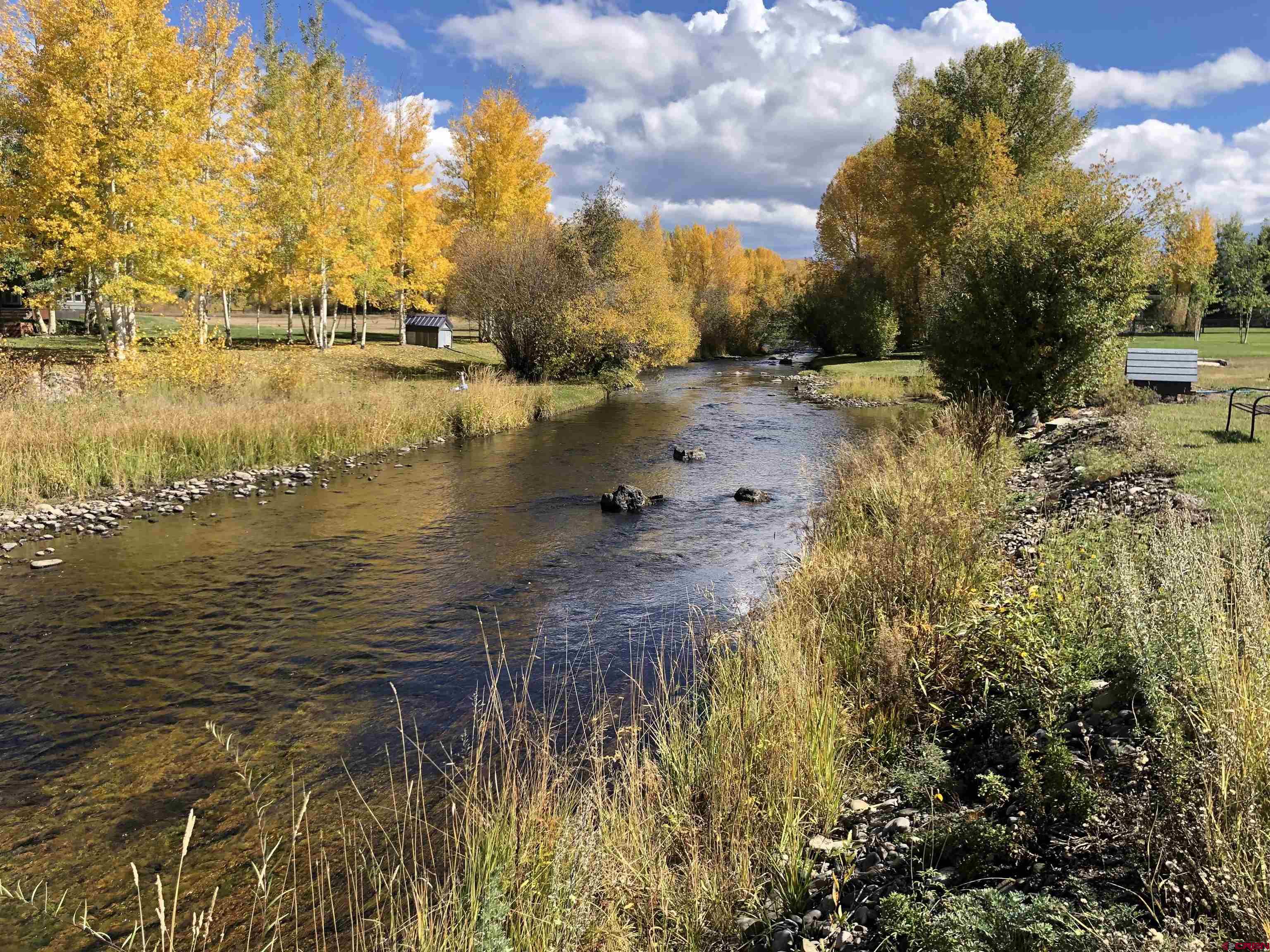 205 Spring Meadow Trail Gunnison, CO 81230 - Photo 11 of 34 a view of a lake with houses in the back