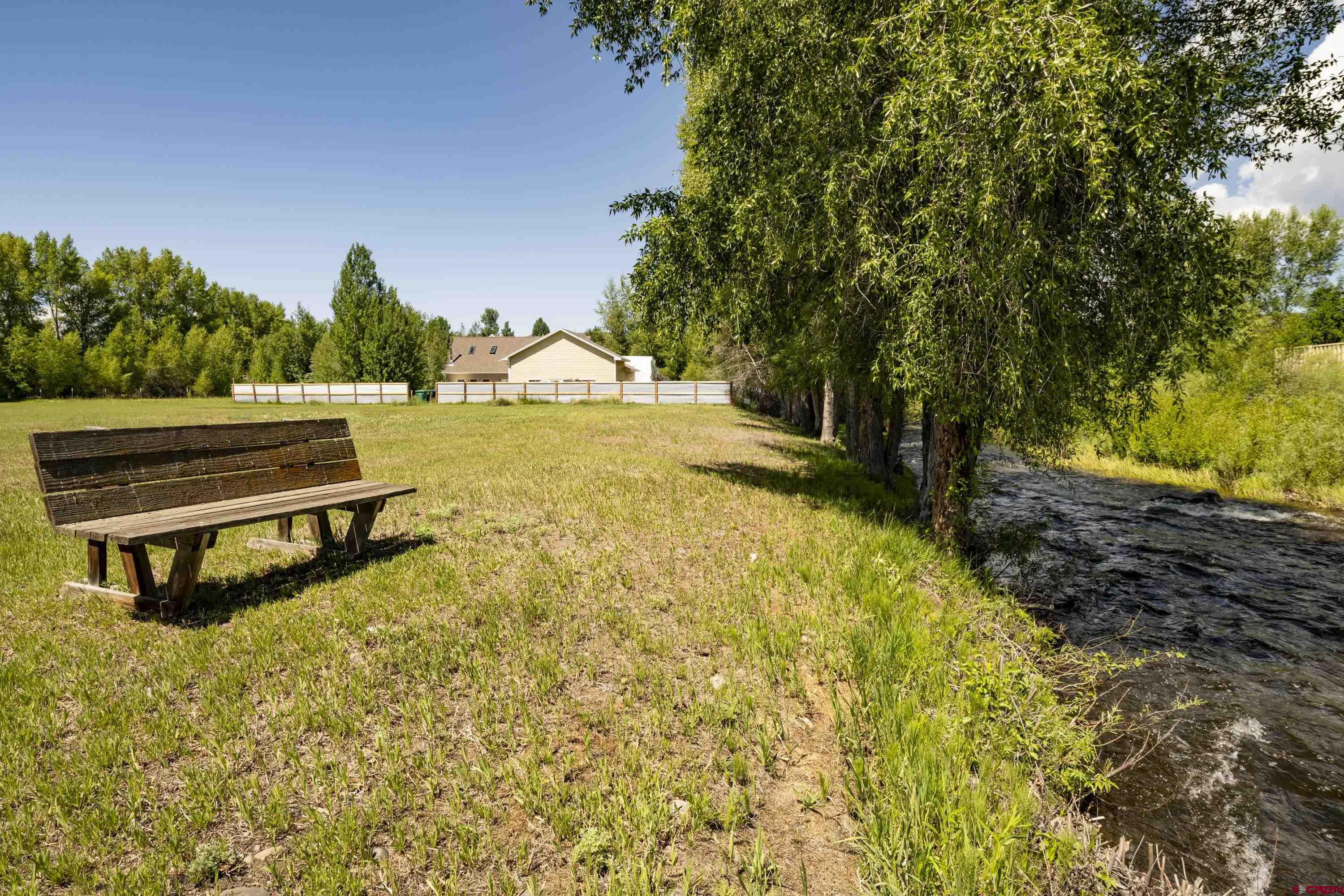 205 Spring Meadow Trail Gunnison, CO 81230 - Photo 6 of 34 a view of a lake with a yard