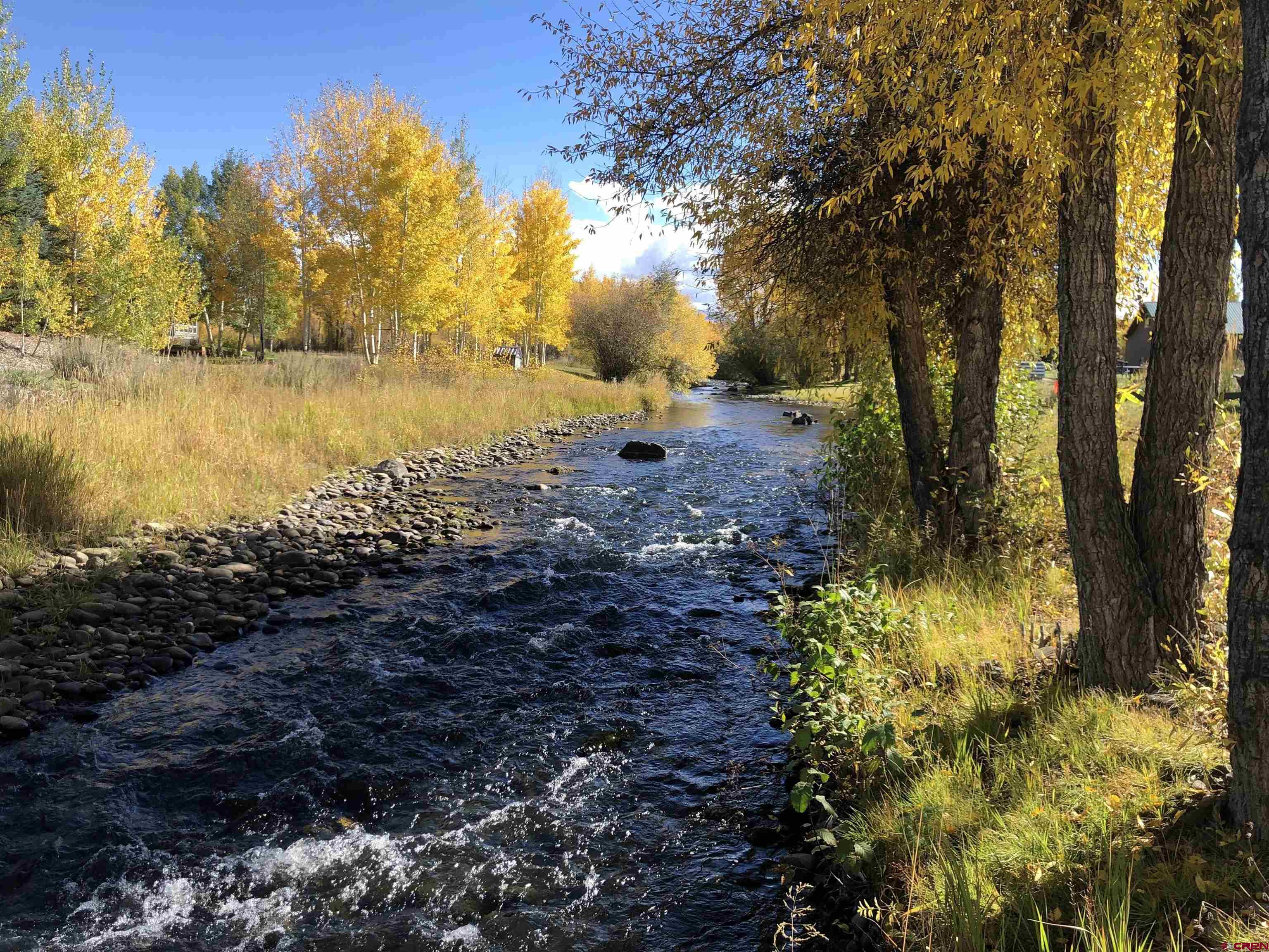 205 Spring Meadow Trail Gunnison, CO 81230 - Photo 9 of 34 a view of a lake with a yard