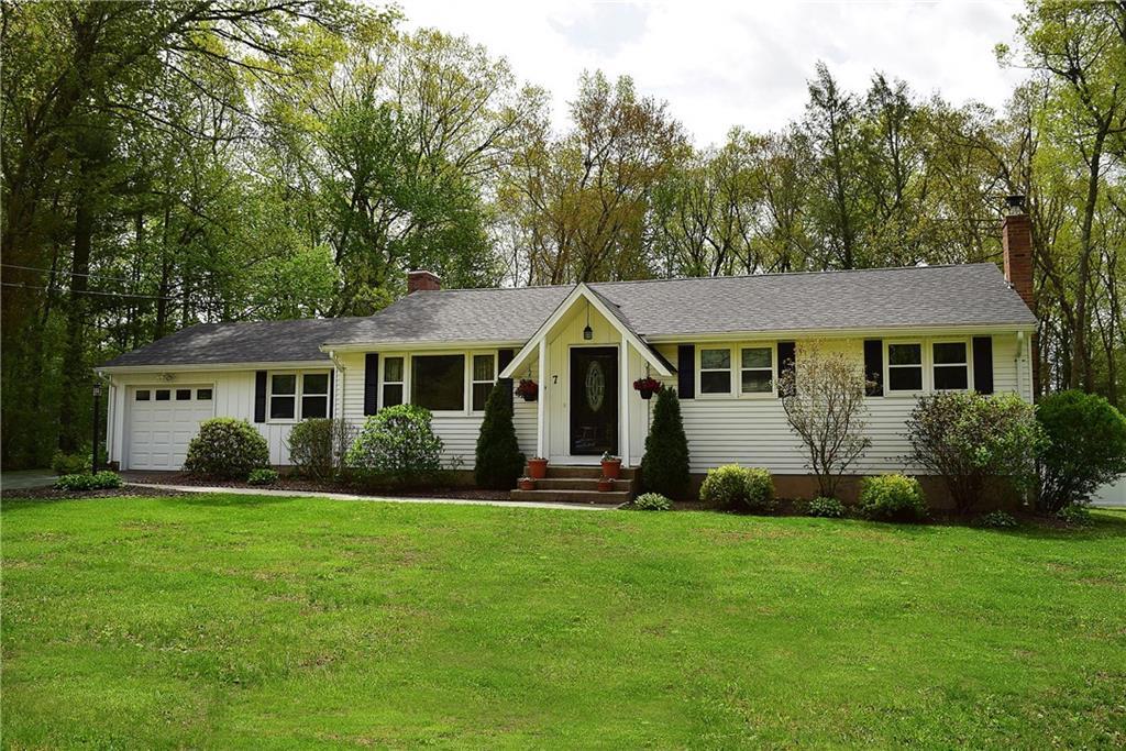 7 Overhill Road Ellington, CT 06029 - Photo 1 of 1 a front view of a house with a garden and yard