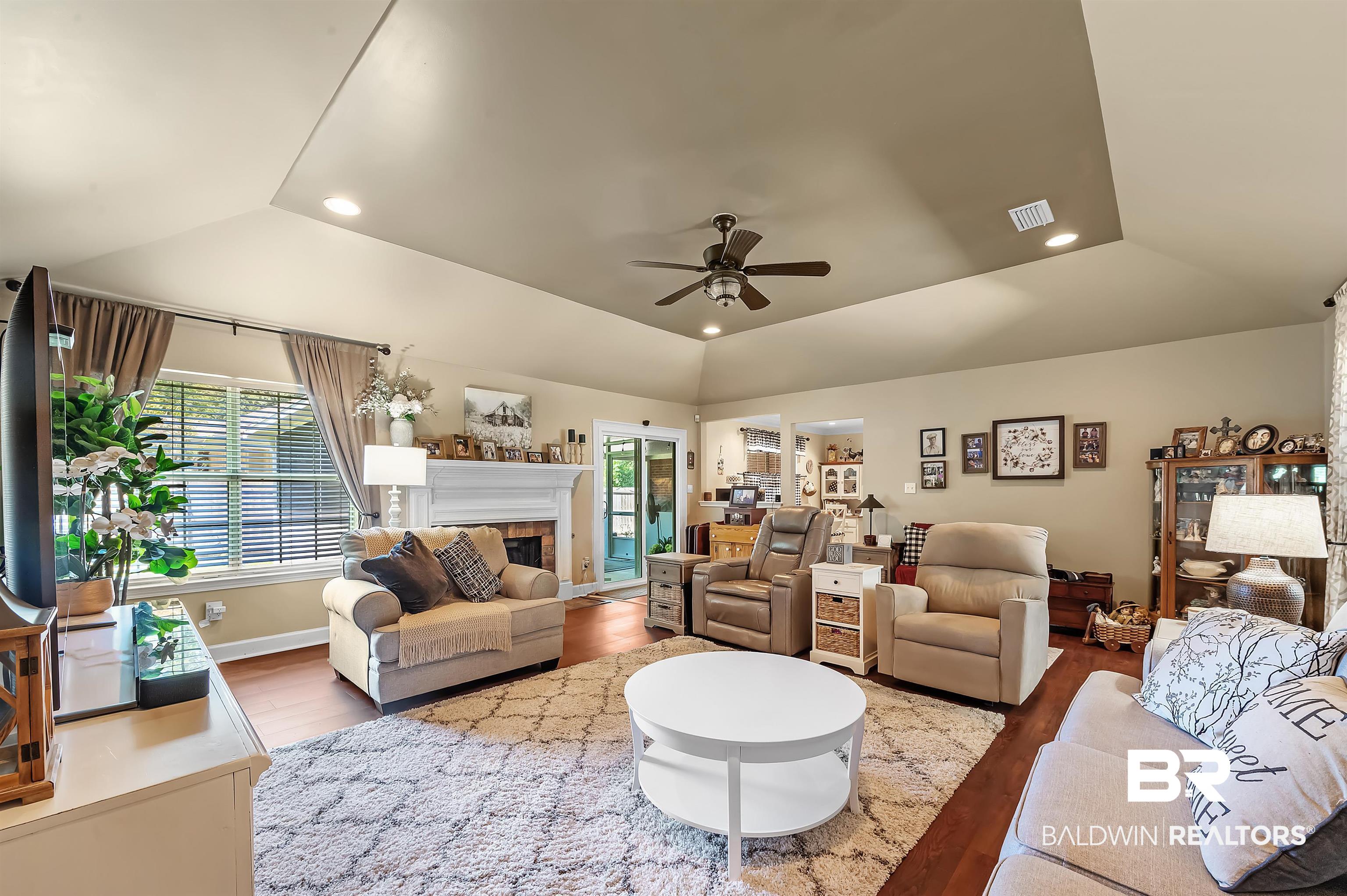 9901 Glover Court Fairhope, AL 36532 - Photo 6 of 52 Living room featuring lofted ceiling, ceiling fan, hardwood / wood-style flooring, and plenty of natural light