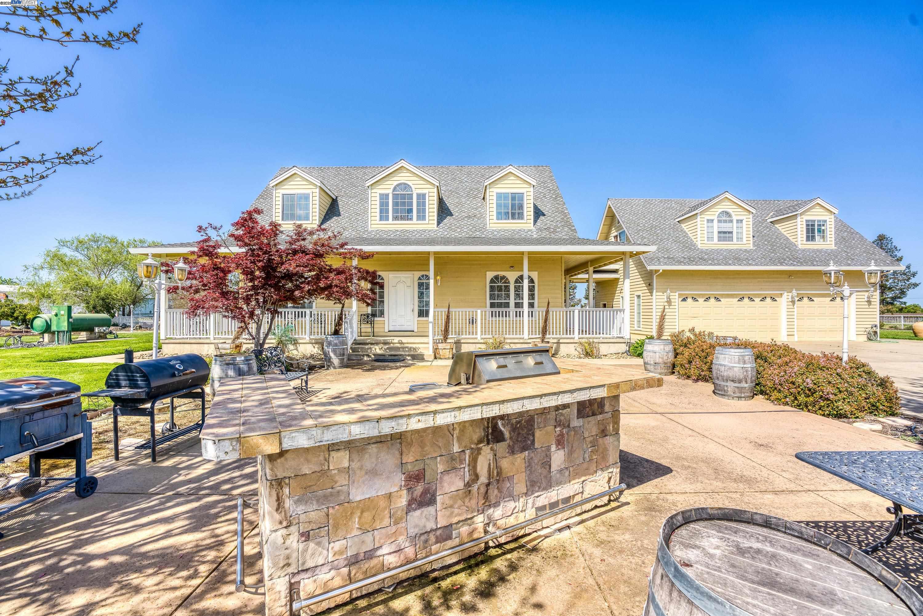 a view of a house with swimming pool and sitting area