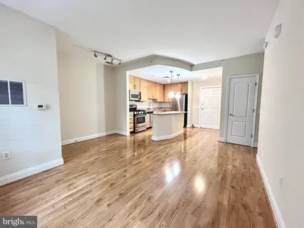 a view of a kitchen and wooden floor
