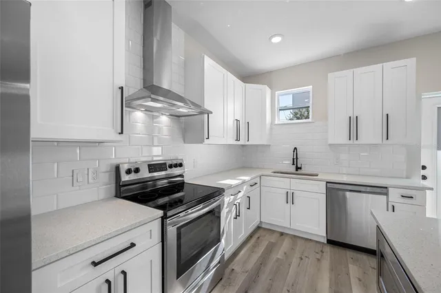 a bathroom with a toilet sink vanity and mirror