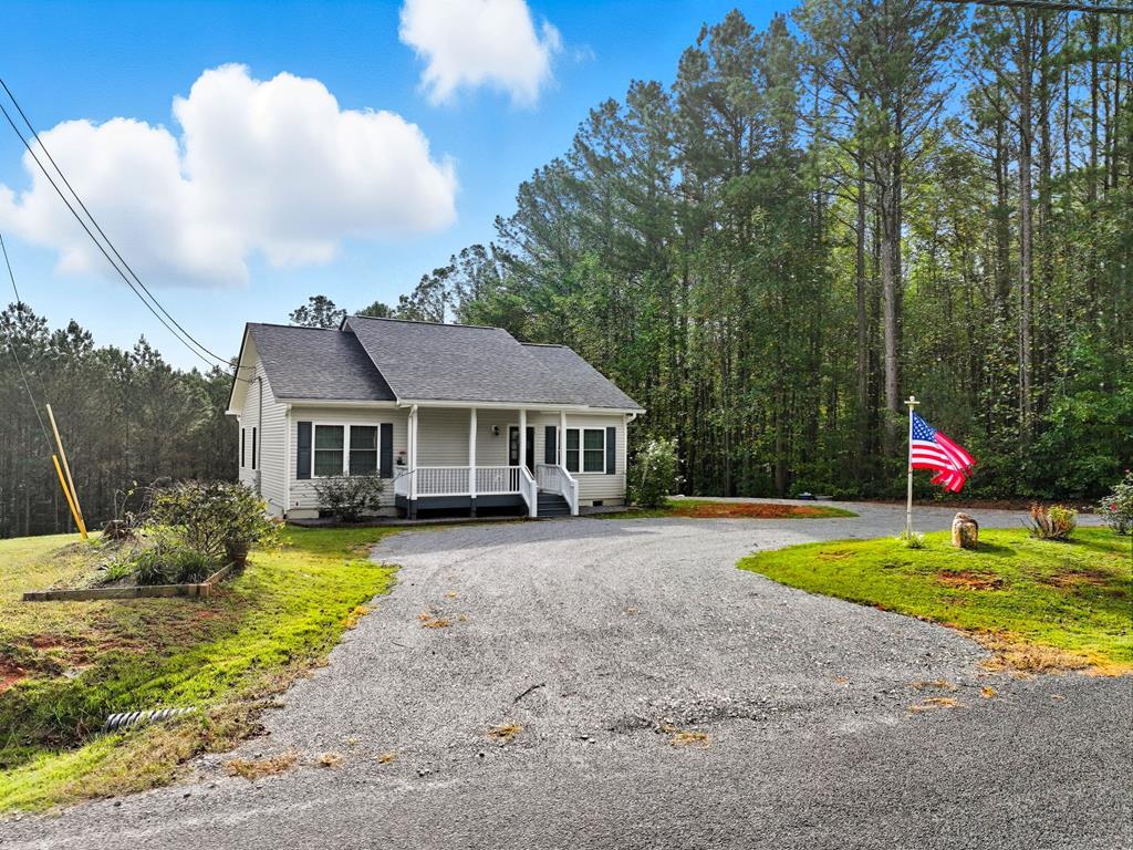 716 Old Pleasant Valley Road Talking Rock, GA 30175 - Photo 3 of 58 a front view of a house with a yard and trees