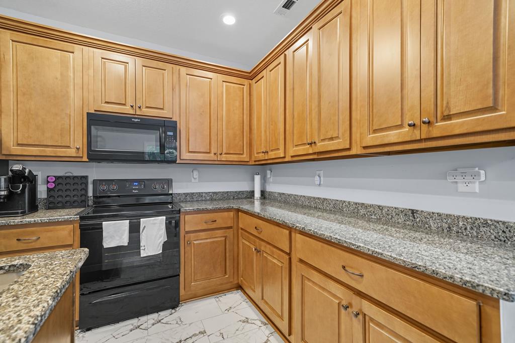 716 Old Pleasant Valley Road Talking Rock, GA 30175 - Photo 31 of 58 a kitchen with stainless steel appliances granite countertop a sink a stove and cabinets
