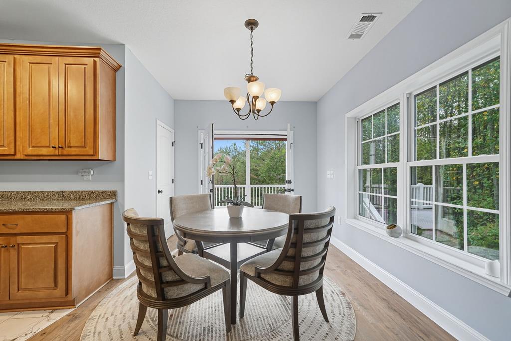 716 Old Pleasant Valley Road Talking Rock, GA 30175 - Photo 33 of 58 a dining room with furniture a chandelier and wooden floor