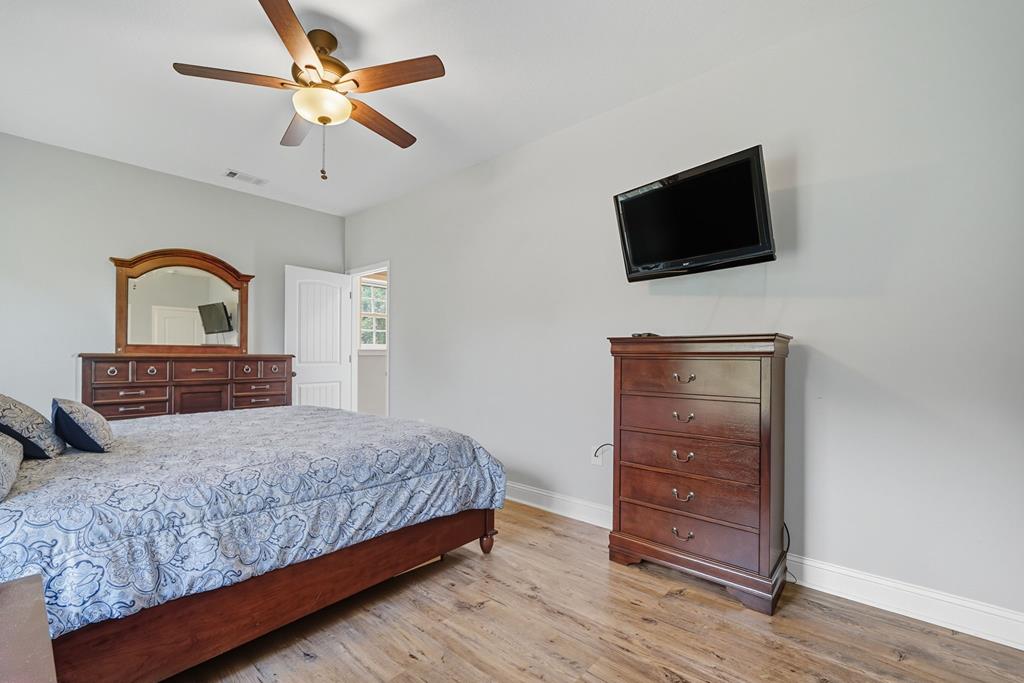 716 Old Pleasant Valley Road Talking Rock, GA 30175 - Photo 41 of 58 a bedroom with a bed and a flat screen tv