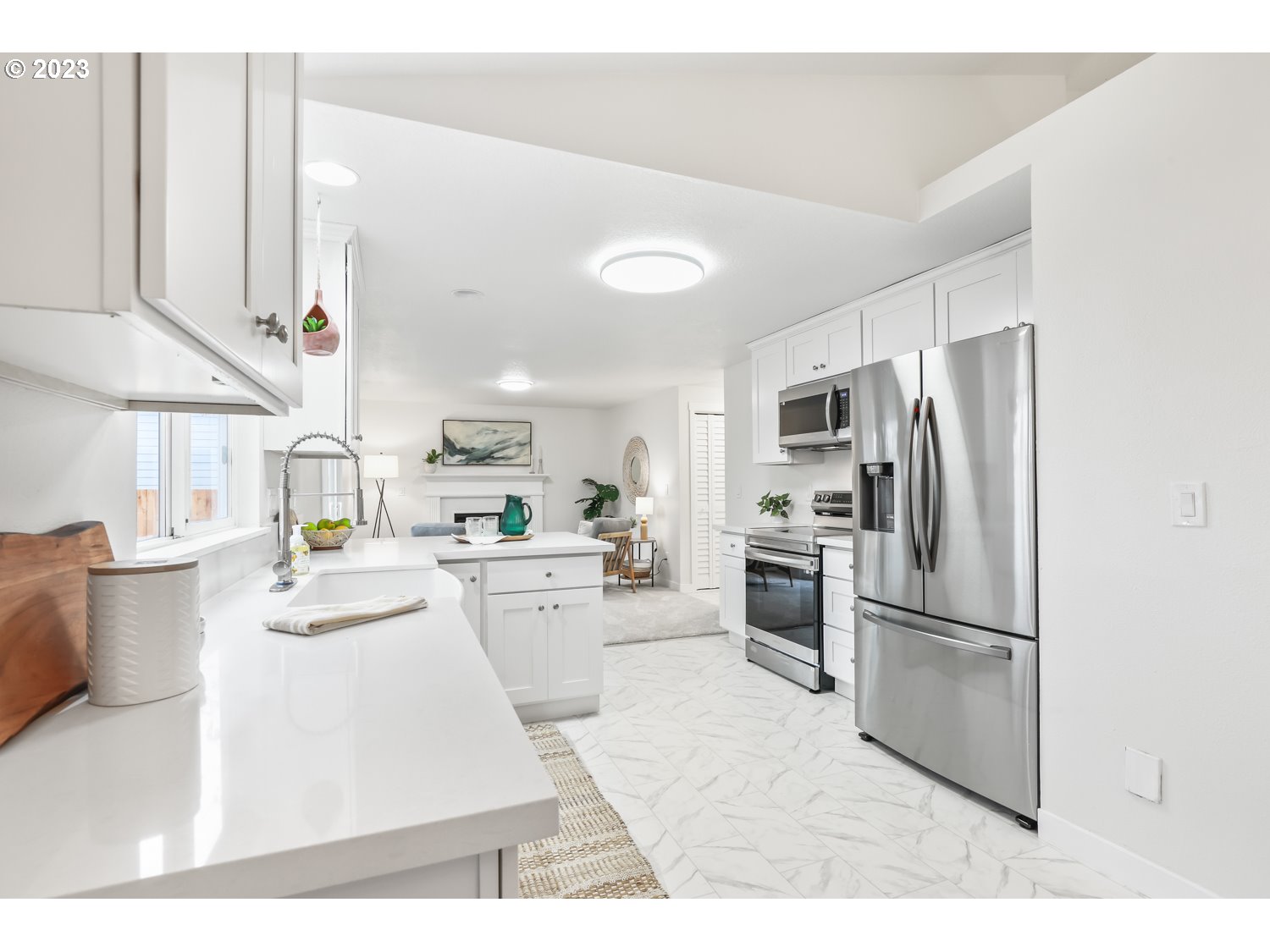 1203 Southeast Barnes Road Gresham, OR 97080 - Photo 11 of 43 a kitchen with refrigerator cabinets and counter space