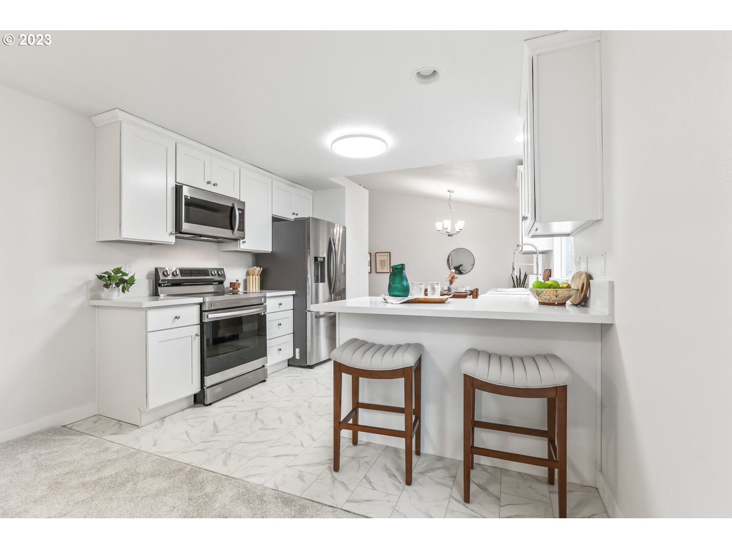 1203 Southeast Barnes Road Gresham, OR 97080 - Photo 16 of 43 a kitchen with kitchen island granite countertop a stove top oven microwave and cabinets