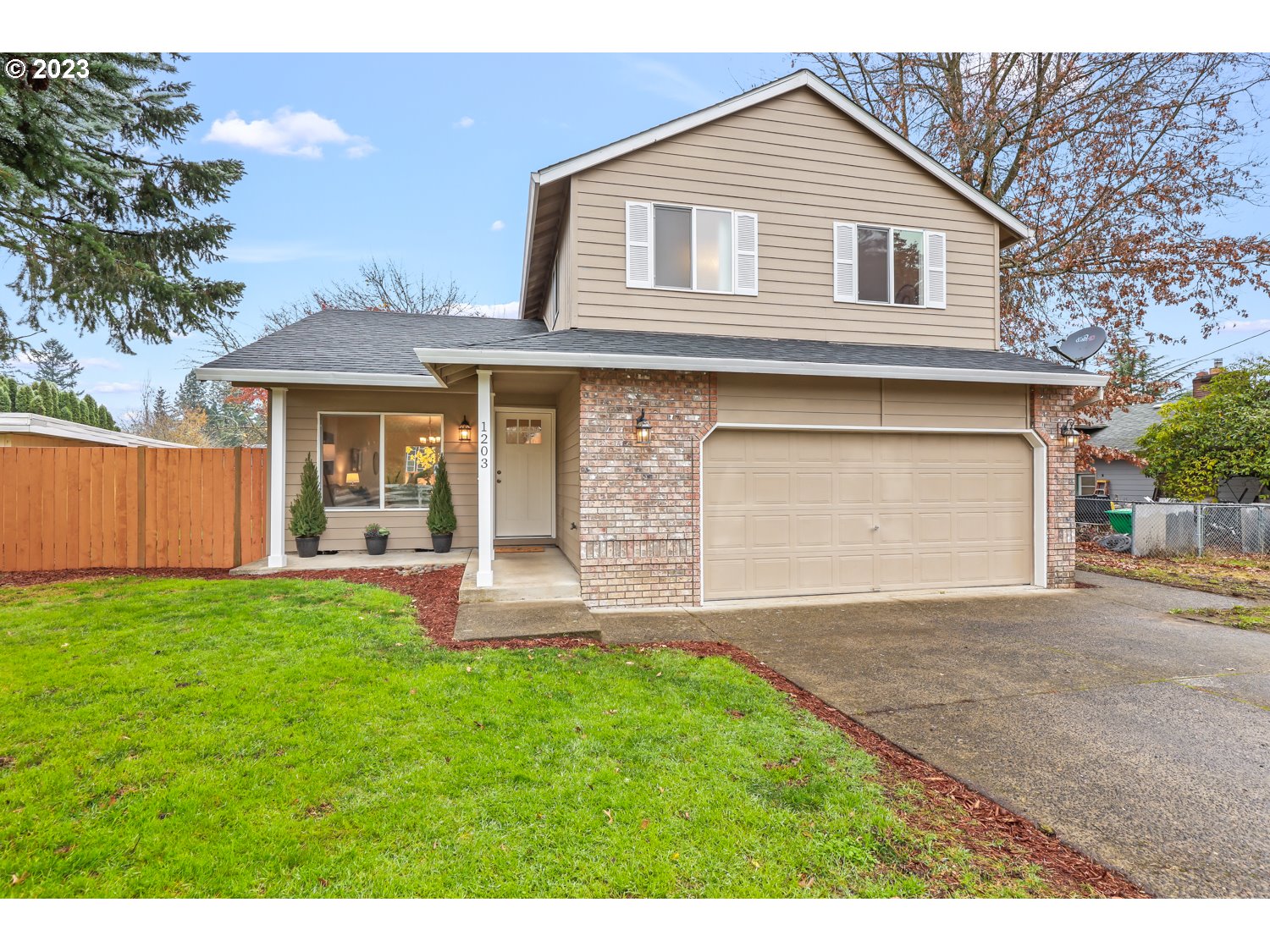 1203 Southeast Barnes Road Gresham, OR 97080 - Photo 2 of 43 a front view of a house with a yard and garage
