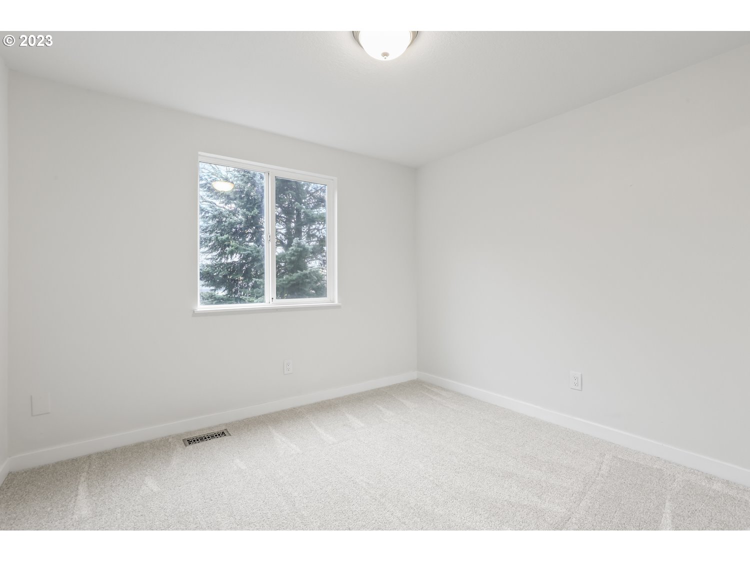 1203 Southeast Barnes Road Gresham, OR 97080 - Photo 25 of 43 an empty room with a window