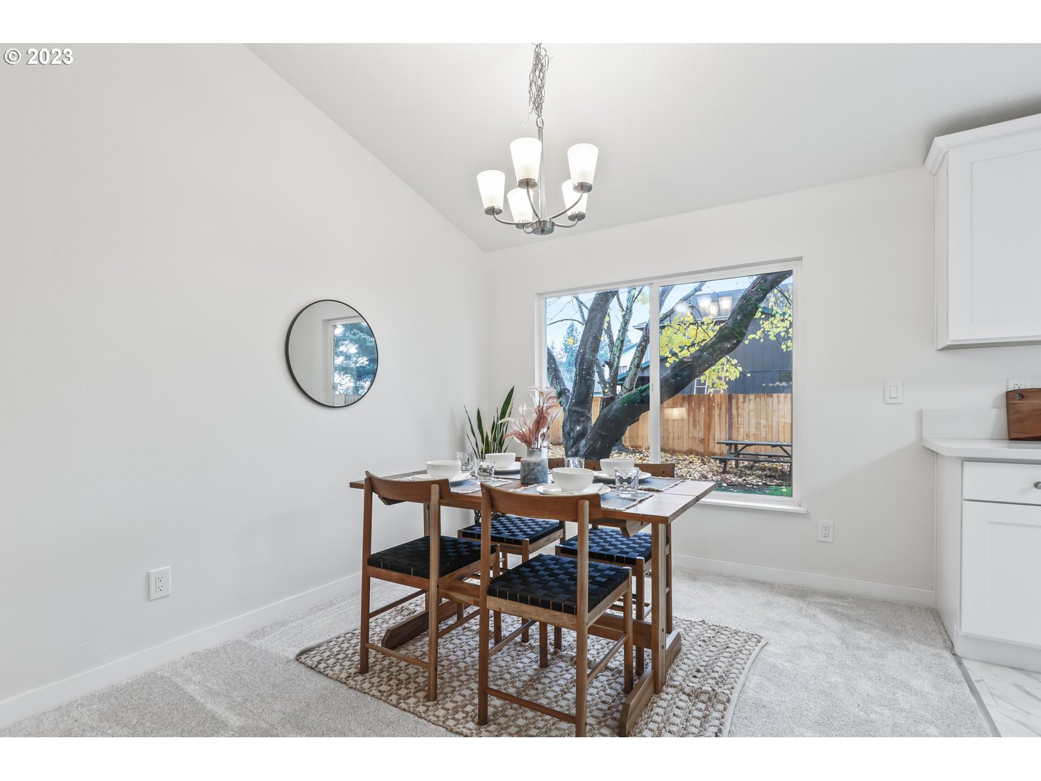 1203 Southeast Barnes Road Gresham, OR 97080 - Photo 7 of 43 a view of a dining room with furniture and a chandelier