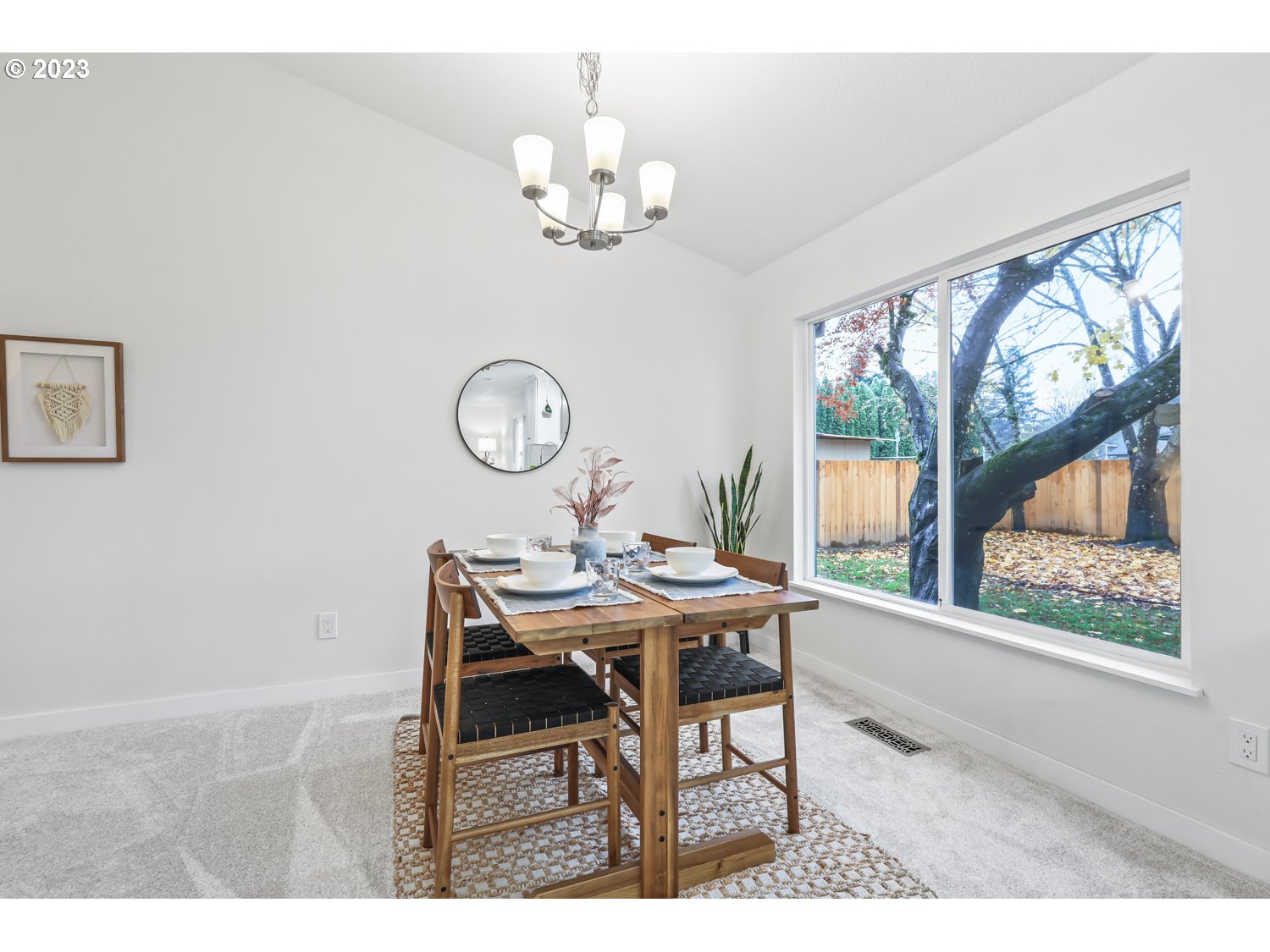 1203 Southeast Barnes Road Gresham, OR 97080 - Photo 8 of 43 a view of a dining room with furniture a chandelier and a large window