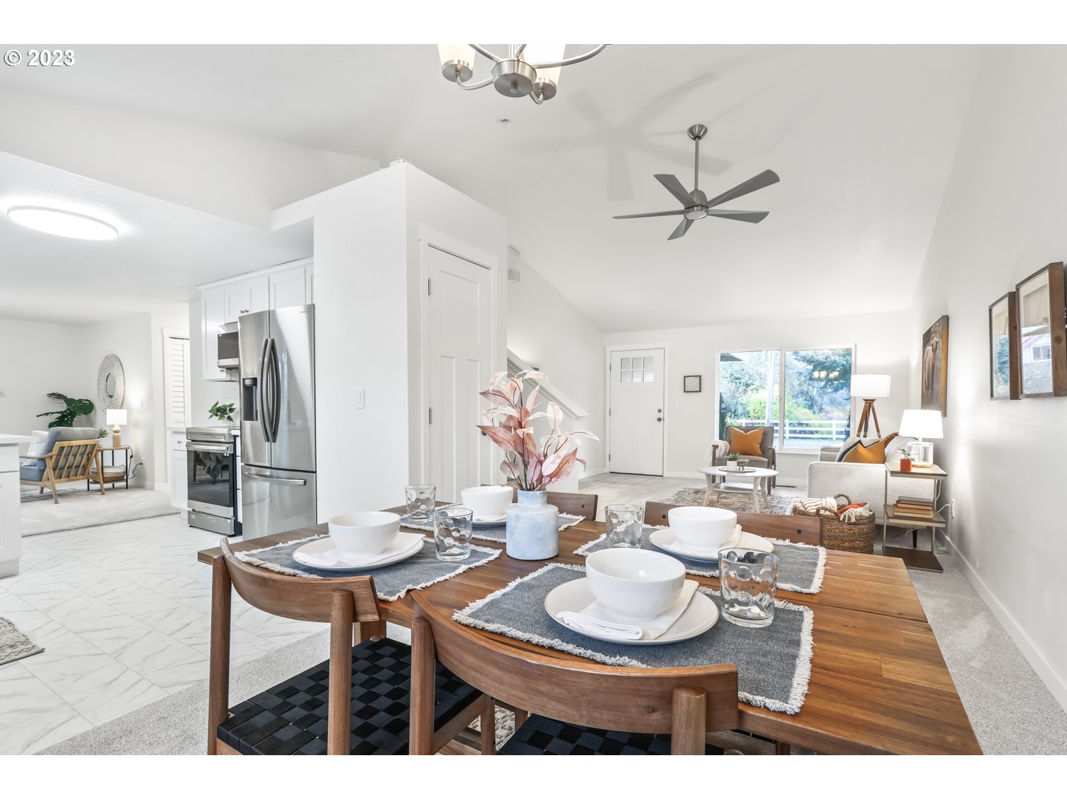 1203 Southeast Barnes Road Gresham, OR 97080 - Photo 10 of 43 a living room with furniture a chandelier and a dining table