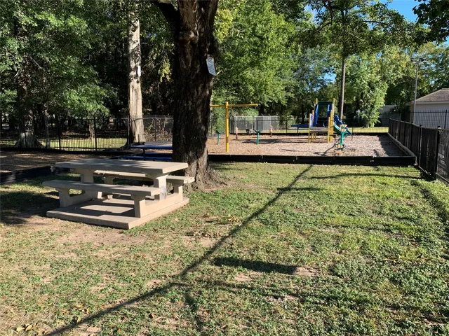a view of swimming pool with chairs and trees