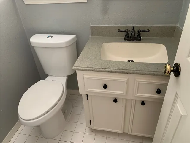 a white toilet sitting next to a white sink