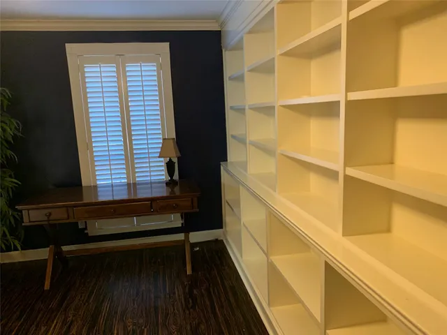 a view of a balcony with wooden floor and a window