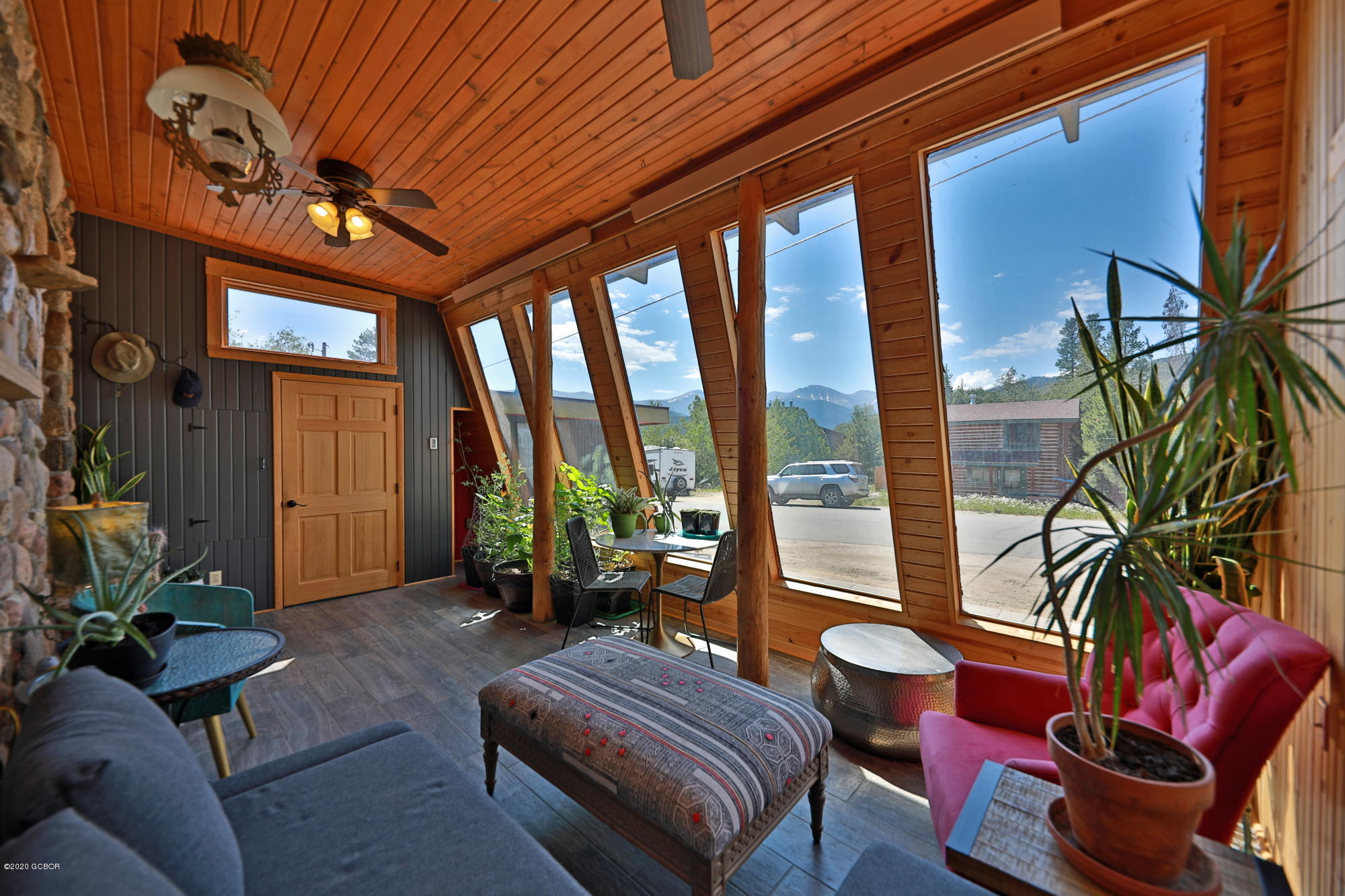 539 Kings Crossing Road Winter Park, CO 80482 - Photo 2 of 35 a living room with furniture and a floor to ceiling window