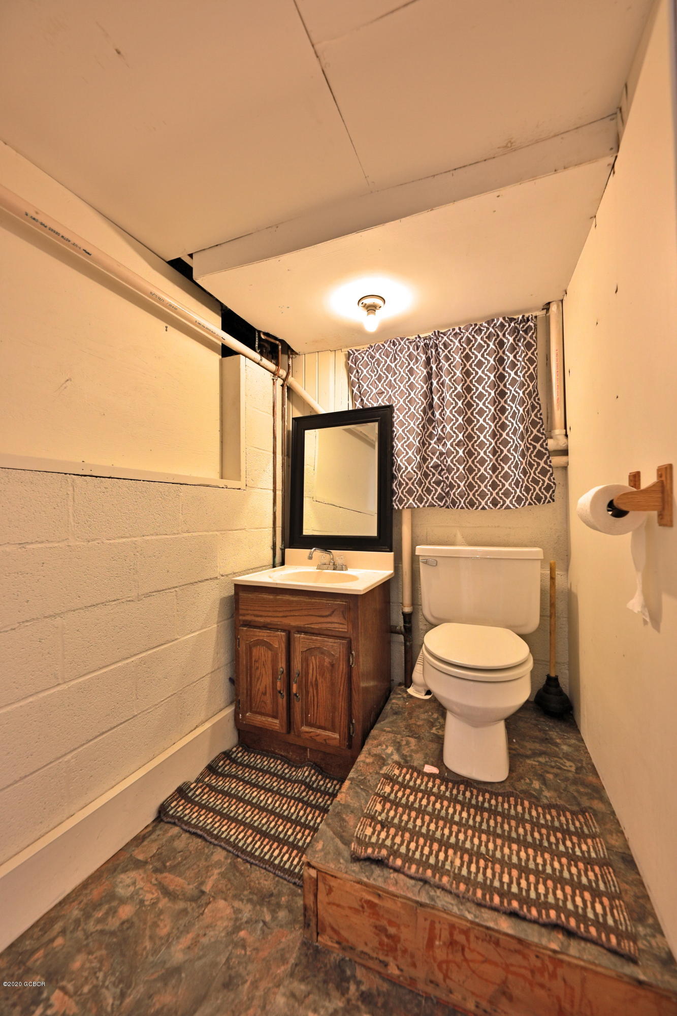 539 Kings Crossing Road Winter Park, CO 80482 - Photo 21 of 35 a bathroom with a toilet a sink and mirror
