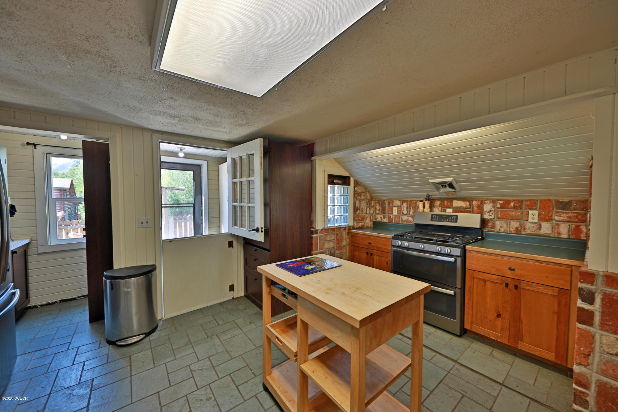 539 Kings Crossing Road Winter Park, CO 80482 - Photo 9 of 35 a kitchen with a stove a sink a refrigerator and wooden cabinets