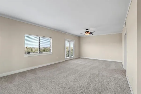 an empty room with windows and cabinet