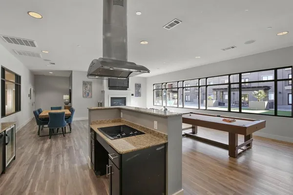 a kitchen with a stove and wooden floor