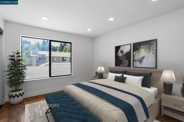 a bedroom with a large bed and a potted plant